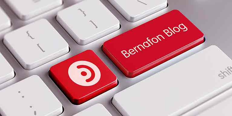 Picture of white keyboard with two tabs changed to red with the Bernafon logo and the text Bernafon blog