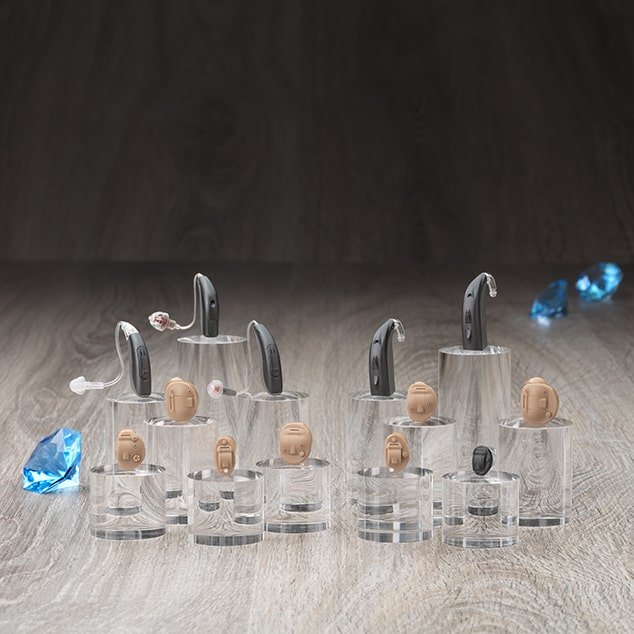 Photo of the Saphira Bernafon hearing aid family including in the ear and behind the ear discreet hearing aids